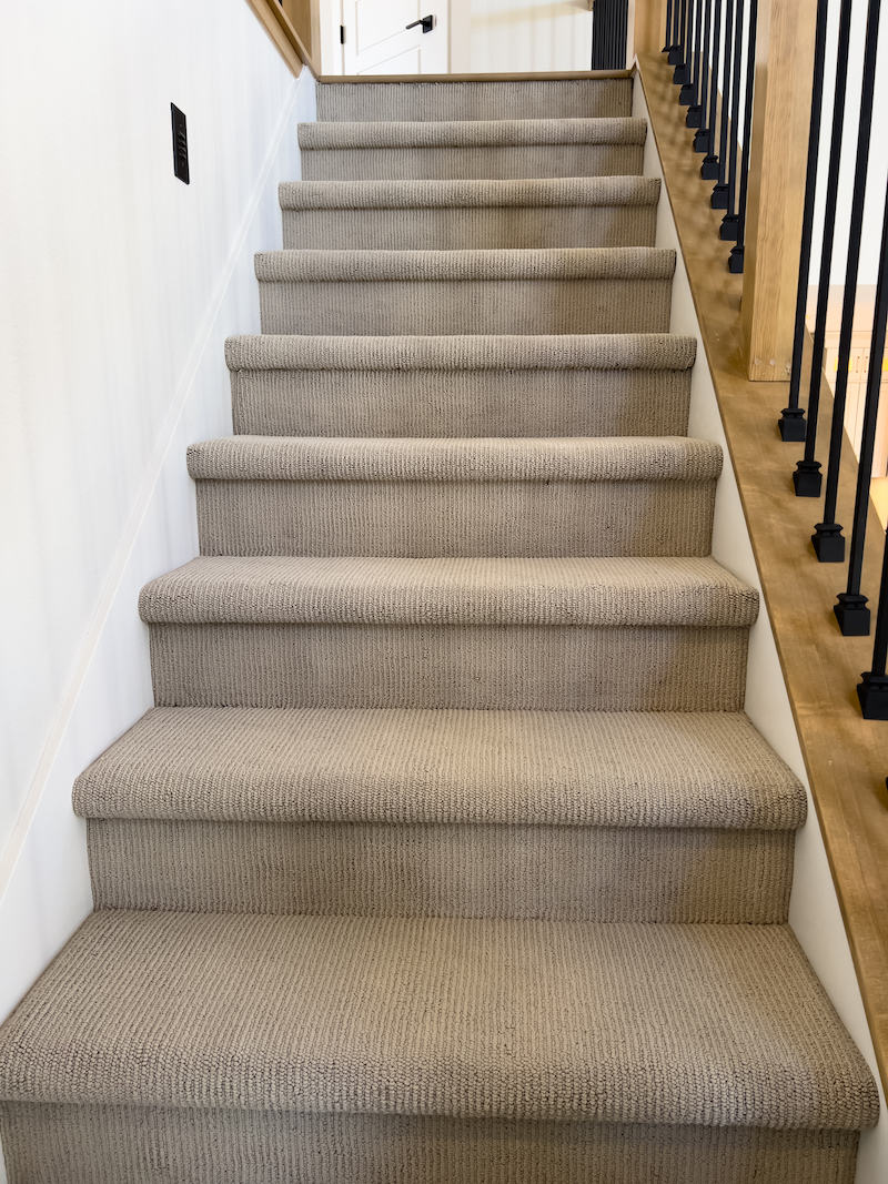 Carpets professionally supplied and installed up a staircase by UK Carpets and Curtains.