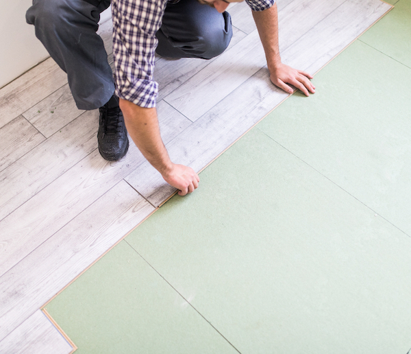 Laminate floor being installed on top of underlay by UK Carpets and Curtains.
